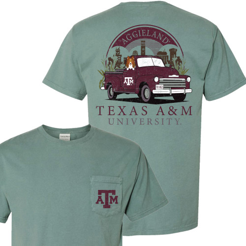 Sage green Texas A&M shirt with pocket ATM logo on the front and a vintage maroon pickup with Reveille and Aggieland artwork on the back.