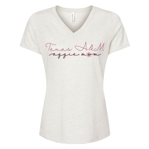 Oatmeal colored v-neck t-shirt that says "Texas A&M" in pink script font centered above "aggie mom" in maroon script font, with the "o" as a pink daisy.