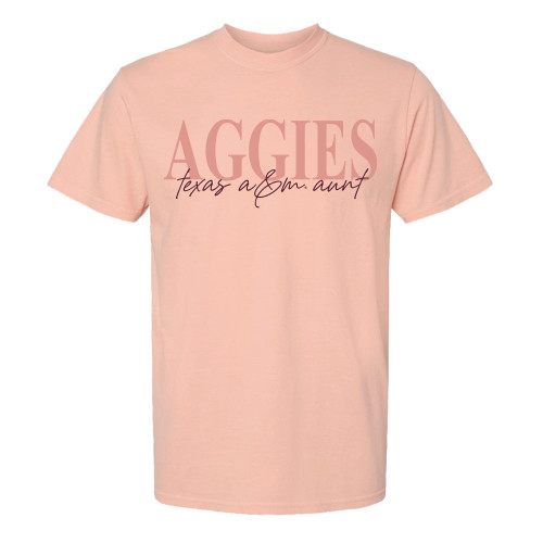 Peach t-shirt saying AGGIES in darker peach ink and "texas a&m aunt" in maroon script font below.