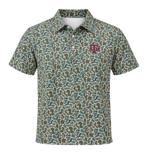 Texas A&M short-sleeve polo featuring an allover green, tan, and cream camouflage pattern, button placket, pointed collar, and maroon embroidered A&M logo on the left chest.