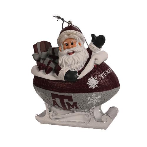 Texas A&M Santa sleigh Christmas ornament featuring Santa riding in a maroon football shaped sleigh with Texas A&M logo and snowflakes for Aggies.