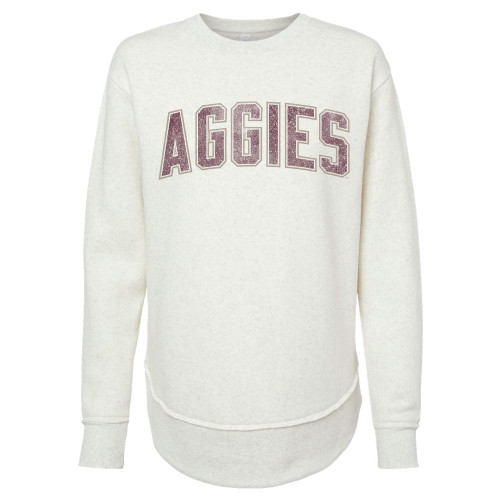 Cream crewneck sweatshirt with distressed maroon “Aggies” lettering across the chest and drop-tail hem. Cream crewneck sweatshirt with distressed maroon “Aggies” lettering across the chest and drop-tail hem.