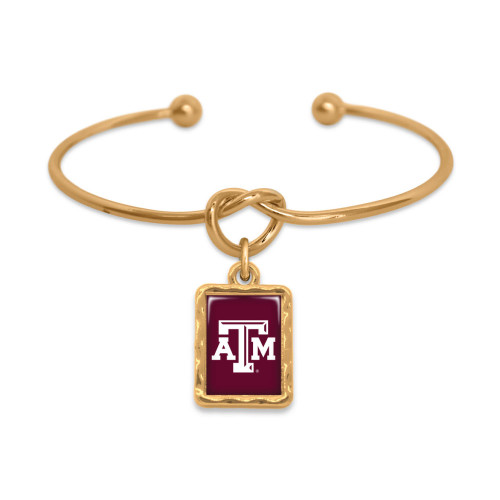 Texas A&M gold-tone bangle bracelet with knot design and maroon rectangular ATM logo charm. Texas A&M gold-tone bangle bracelet with knot design and maroon rectangular ATM logo charm.