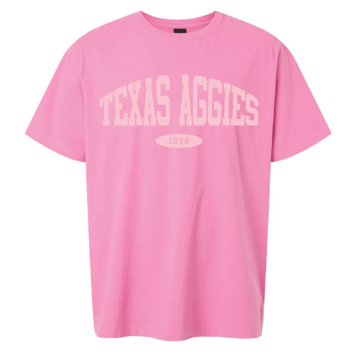 Pink Texas Aggies t shirt with arched white “Texas Aggies” lettering and “1876” centered on the front