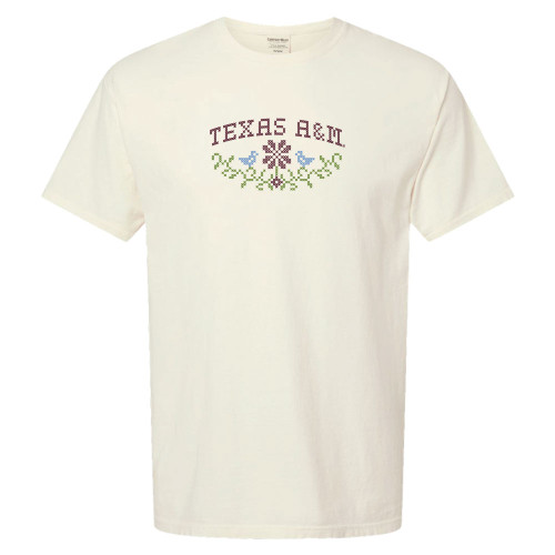 Texas A&M cream t shirt with cross stitch style lettering and floral design on the front