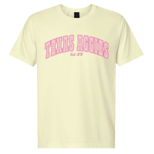 Light yellow Texas A&M University t shirt with pink Texas Aggies Est 1876 arched lettering on front