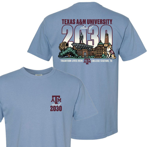 Light blue Texas A&M Class of 2030 t shirt with small front chest ATM logo and large back graphic featuring campus landmarks, Reveille, and “Tradition Lives Here” text