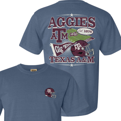 Washed blue Texas A&M football t shirt featuring a large collage style back graphic with “Aggies” lettering, ATM logo, football field, Gig ’Em pennant, maroon football helmet, and “Est. 1876” details, along with a small maroon football helmet graphic on the front chest
