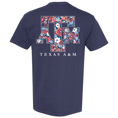 Navy Texas A&M T-shirt featuring a small floral "Texas A&M Aggies" graphic on the front and a large floral-pattern A&M logo on the back with colorful flowers in shades of blue, coral, white, and pink.