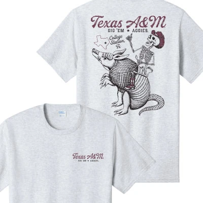 Heather gray Texas A&M T-shirt featuring a skeleton Aggie in a cowboy hat riding an armadillo and giving a Gig ’Em, with Texas A&M and College Station lettering.