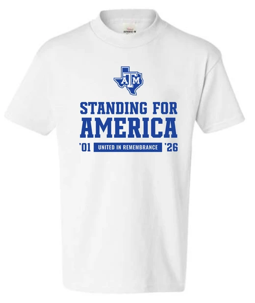 Youth white Texas A&M T-shirt featuring the Texas A&M logo, bold “Standing for America” lettering, “United in Remembrance,” and ’01 and ’26 commemorative details.