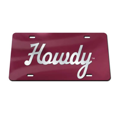 Maroon acrylic license plate featuring large white “Howdy” script across the center with four mounting slots for displaying on a vehicle or as decorative Aggie decor.
