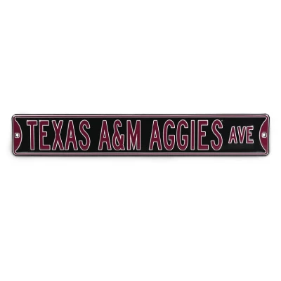 Texas A&M embossed street sign featuring Texas A&M Aggies Ave lettering in maroon and white on a dark background, with a maroon border and mounting holes on each end.