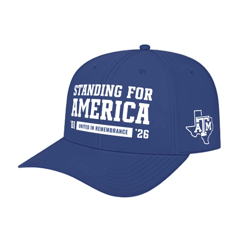 Blue Texas A&M cap featuring white Standing for America and United in Remembrance graphics, a Texas A&M logo inside a Texas outline on the side, and a curved bill.