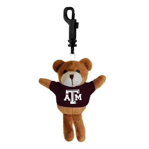 Brown plush Texas A&M bear keychain and bag clip wearing a maroon T-shirt with a white A&M logo, featuring outstretched arms and a black attachment clip at the top.