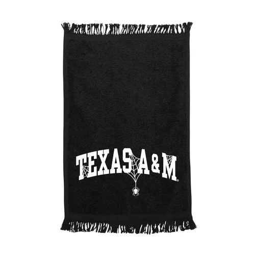 Black Texas A&M Halloween rally towel featuring white Texas A&M lettering with spiderweb accents, a dangling spider graphic, and black fringe along the top and bottom edges.