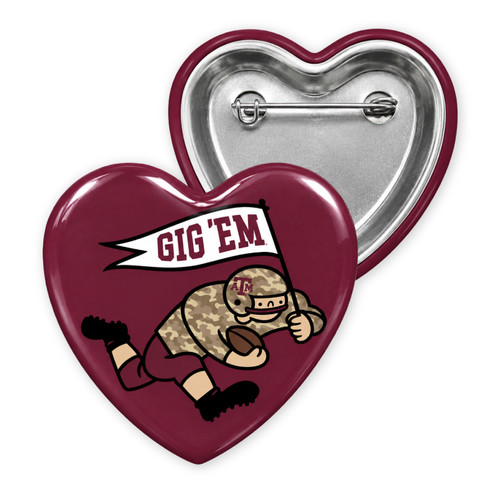 Maroon heart-shaped Texas A&M game-day button featuring a cartoon football player in camouflage carrying a football and white “Gig ’Em” pennant, with a metal pin closure on the back.