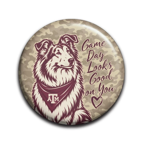 Round Texas A&M game day button featuring a Reveille-inspired dog wearing a maroon A&M bandana, neutral camouflage background, and maroon “Game Day Looks Good on You” lettering with a heart.