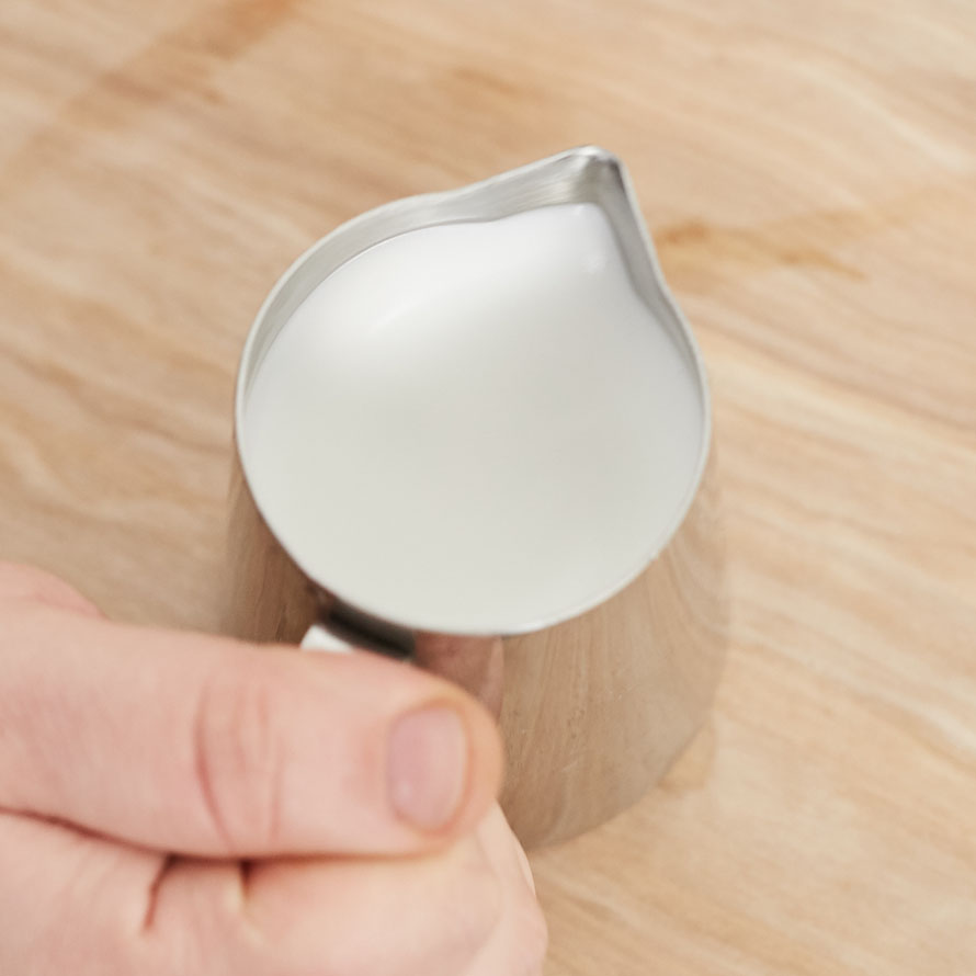 Well textured milk being groomed in a steaming pitcher