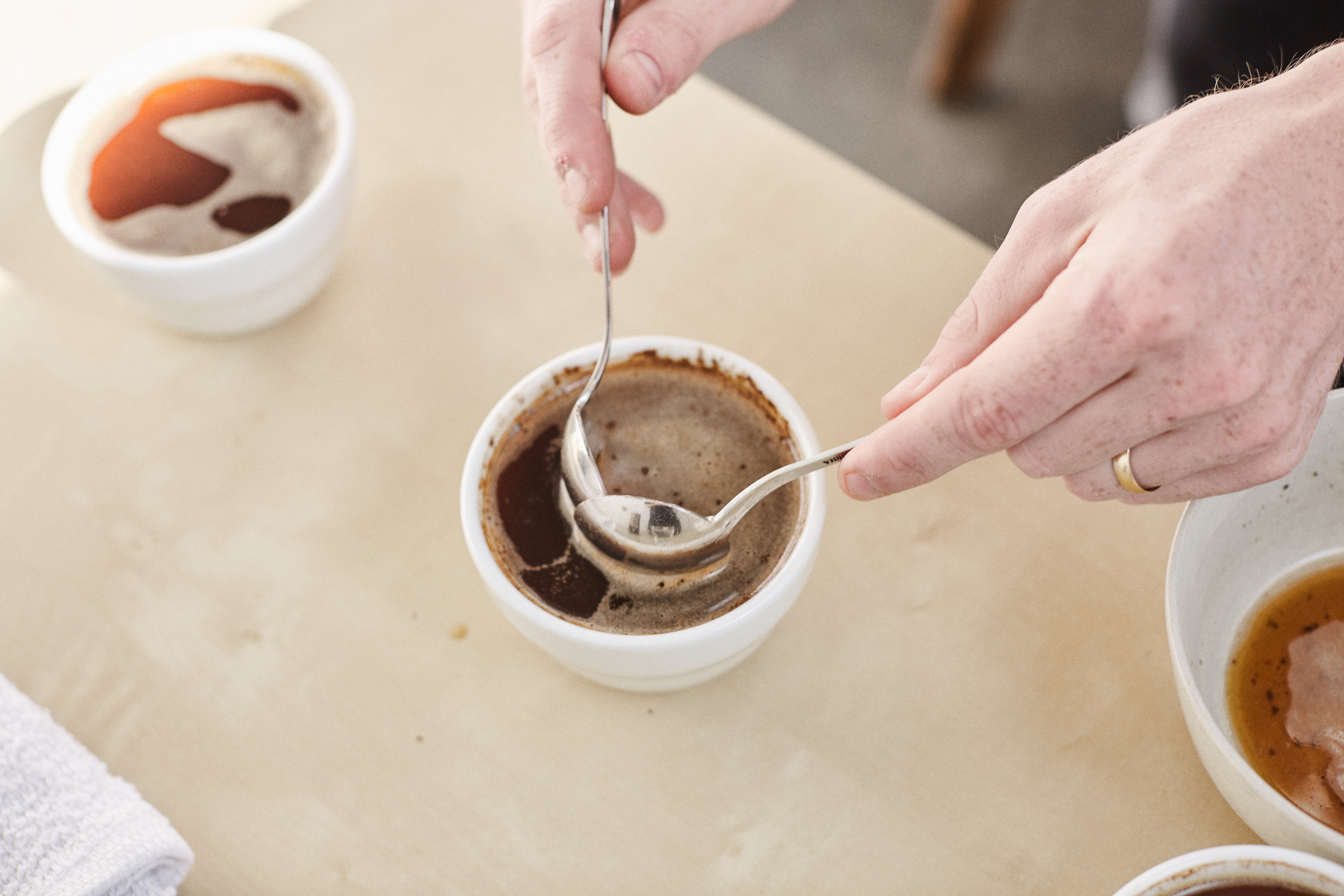 two cupping spoons skimming the cupping bowl