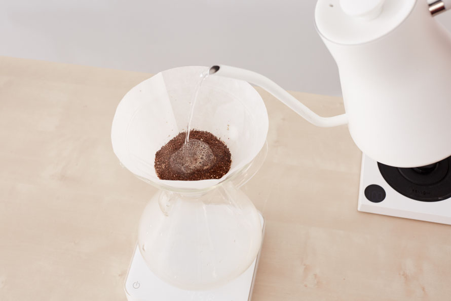 Pouring water into a Chemex to start the bloom phase.