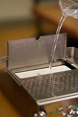 Start by filling your espresso machine with filtered water. Filling an espresso machine with filtered water