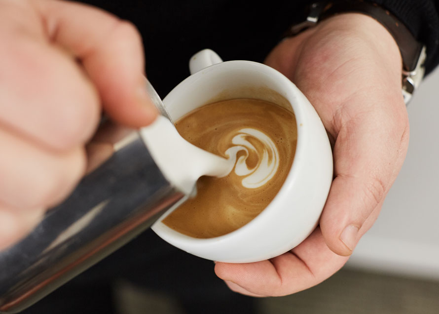 Pouring wiggles in latte art to make a rosetta design
