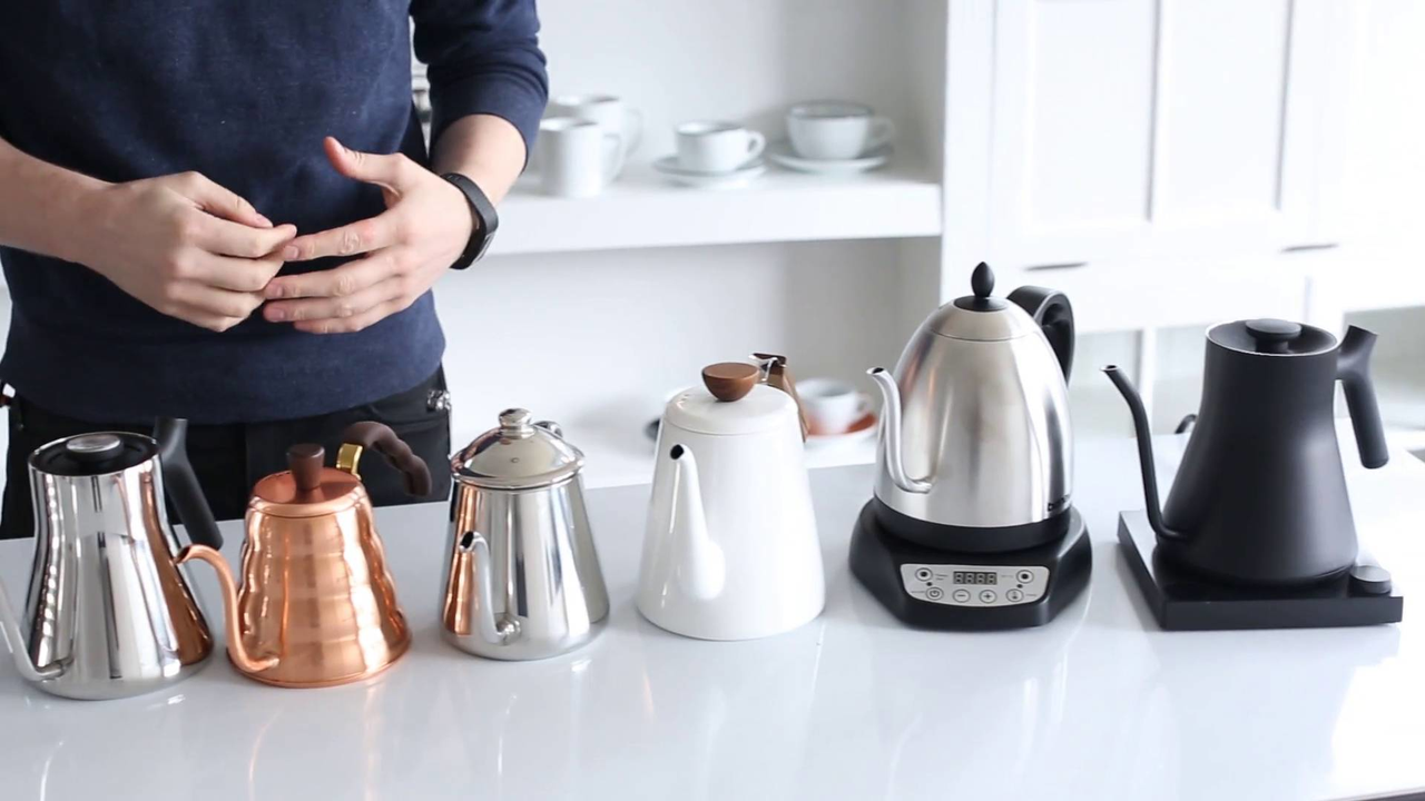 Six kettles sitting on a counter