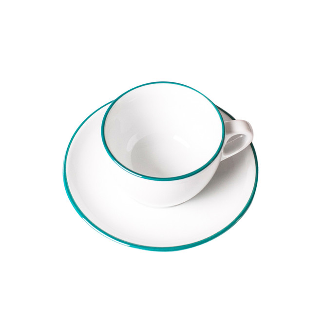 overhead view of teal painted rim cappuccino cup and saucer