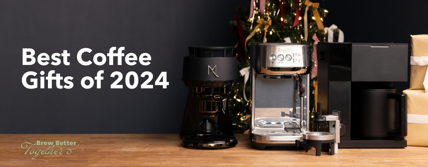 A Fellow Aiden, distribution tool, Breville Bambino Plus and Mx. Cool Aries coffee grinder sitting on a holiday themed table.