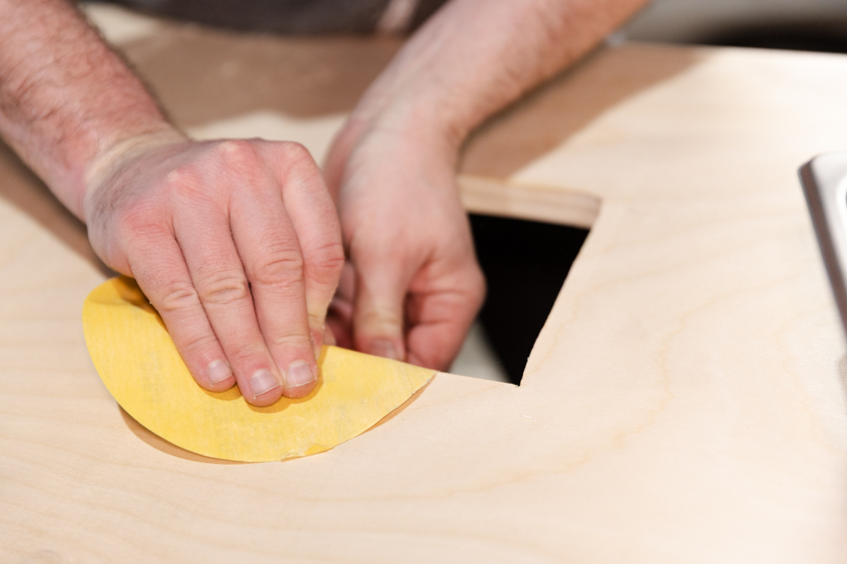 Sanding and cleaning cut edges of countertop