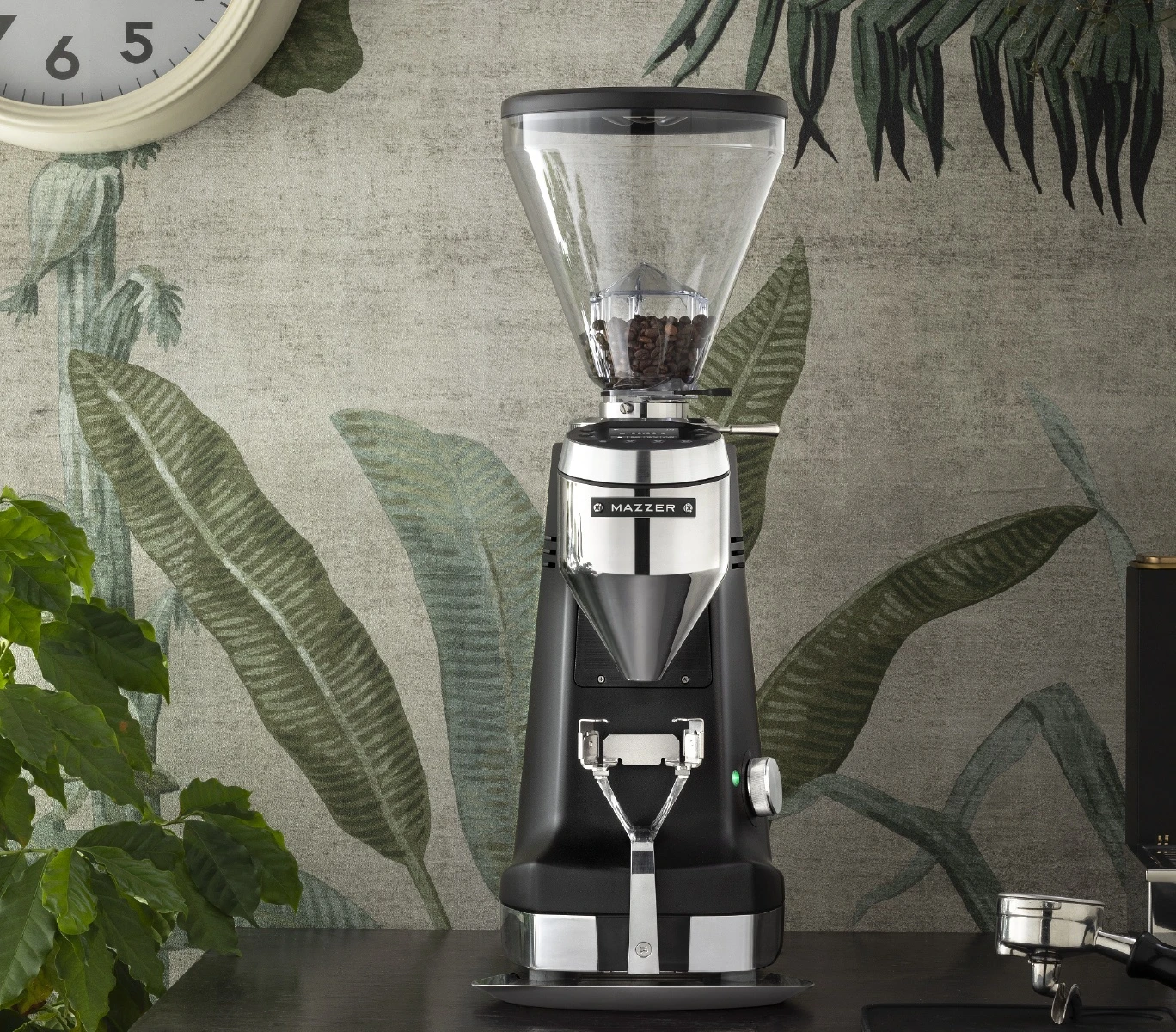Mazzer Super Jolly G Grind-by-Weight espresso grinder, black, on a cafe counter