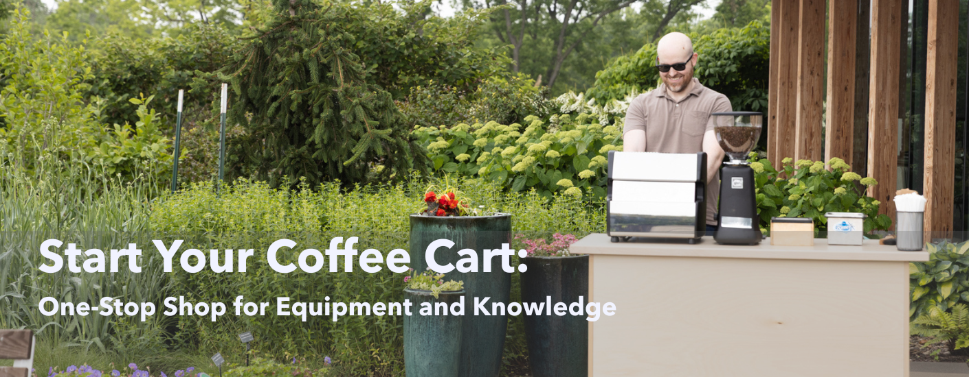 Man and woman standing behind a coffee cart surrounded by Christmas decorations.