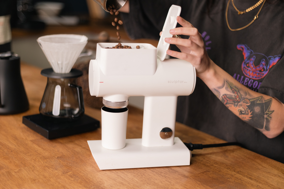 Timemore 064S Sculptor in white, dosing beans into hopper