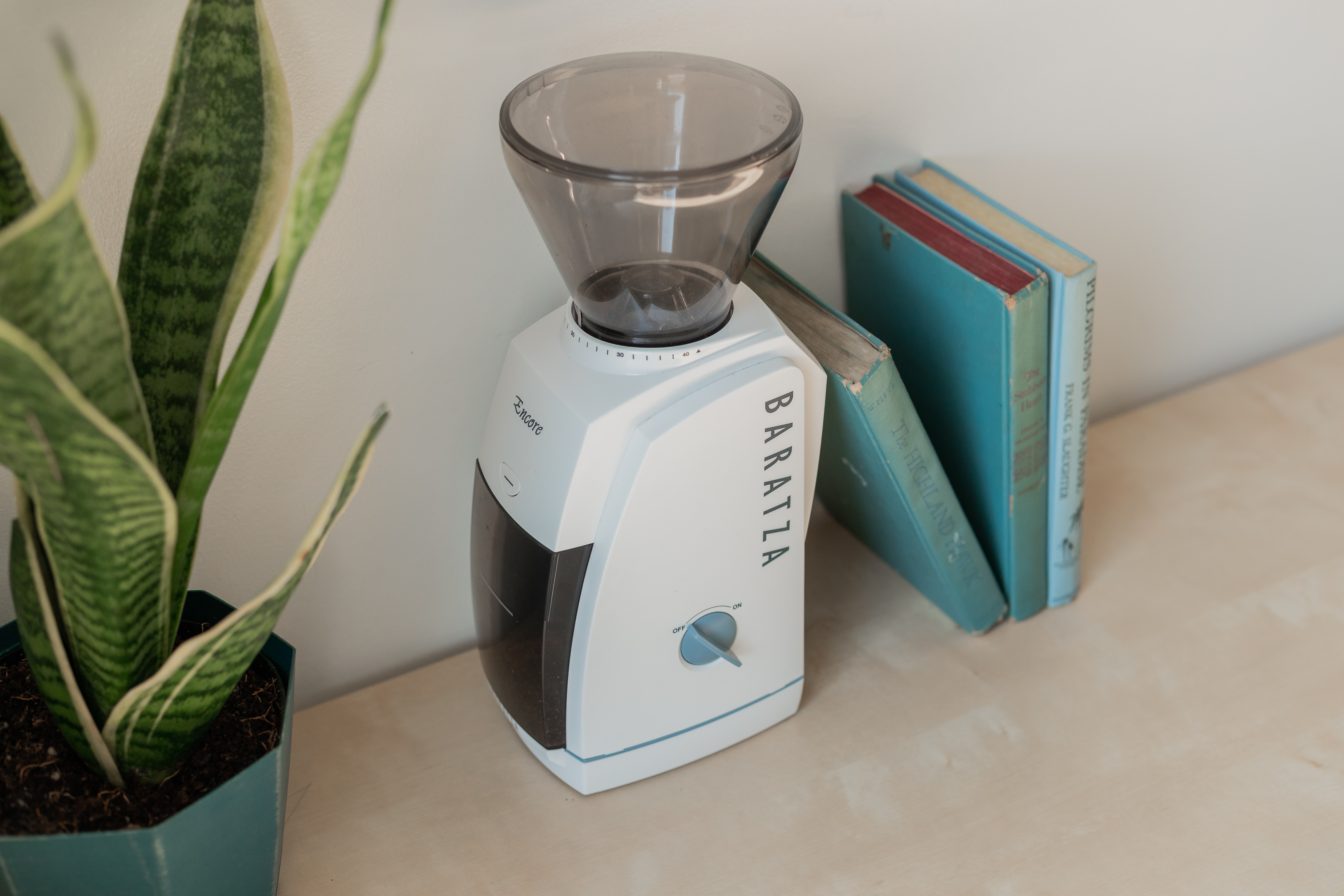 Baratza Encore on a table with books