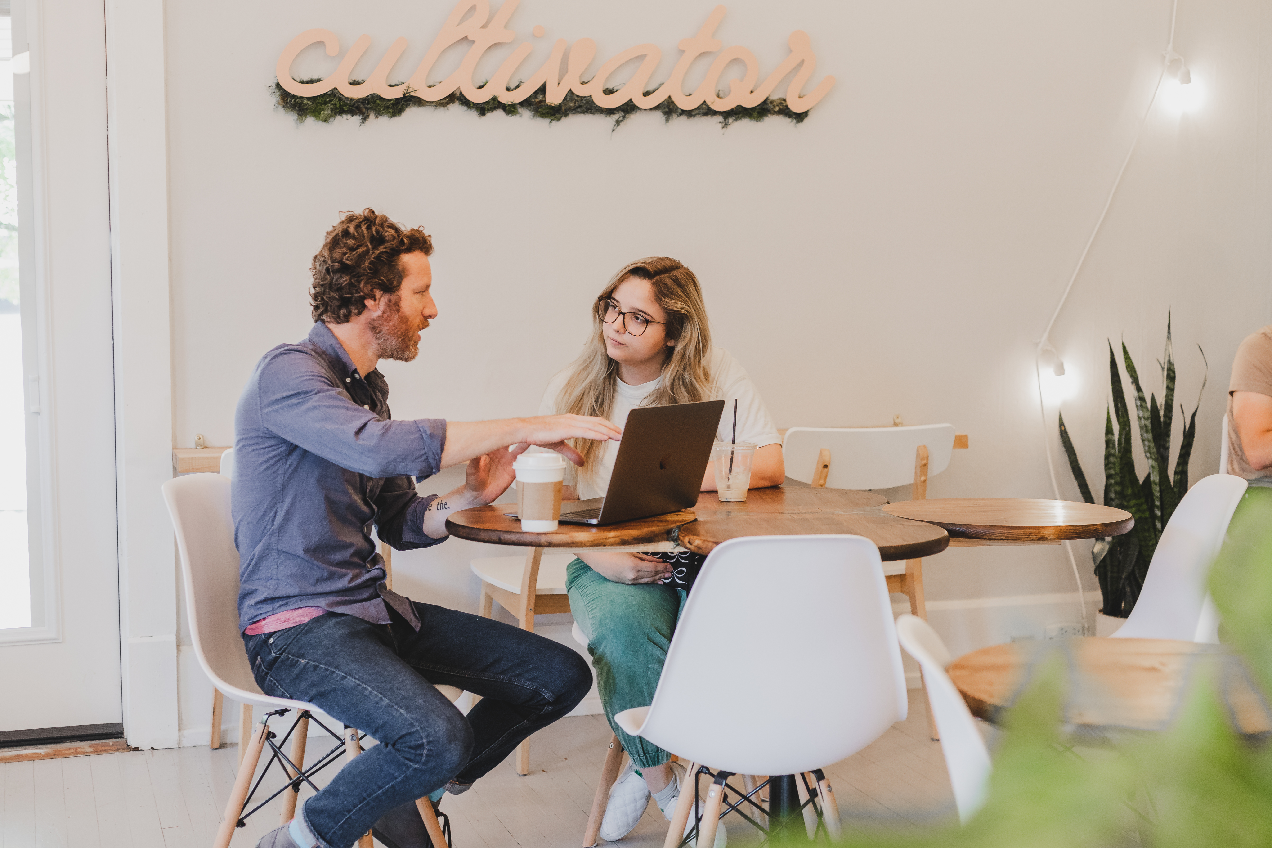 Man and woman sitting at table with computer