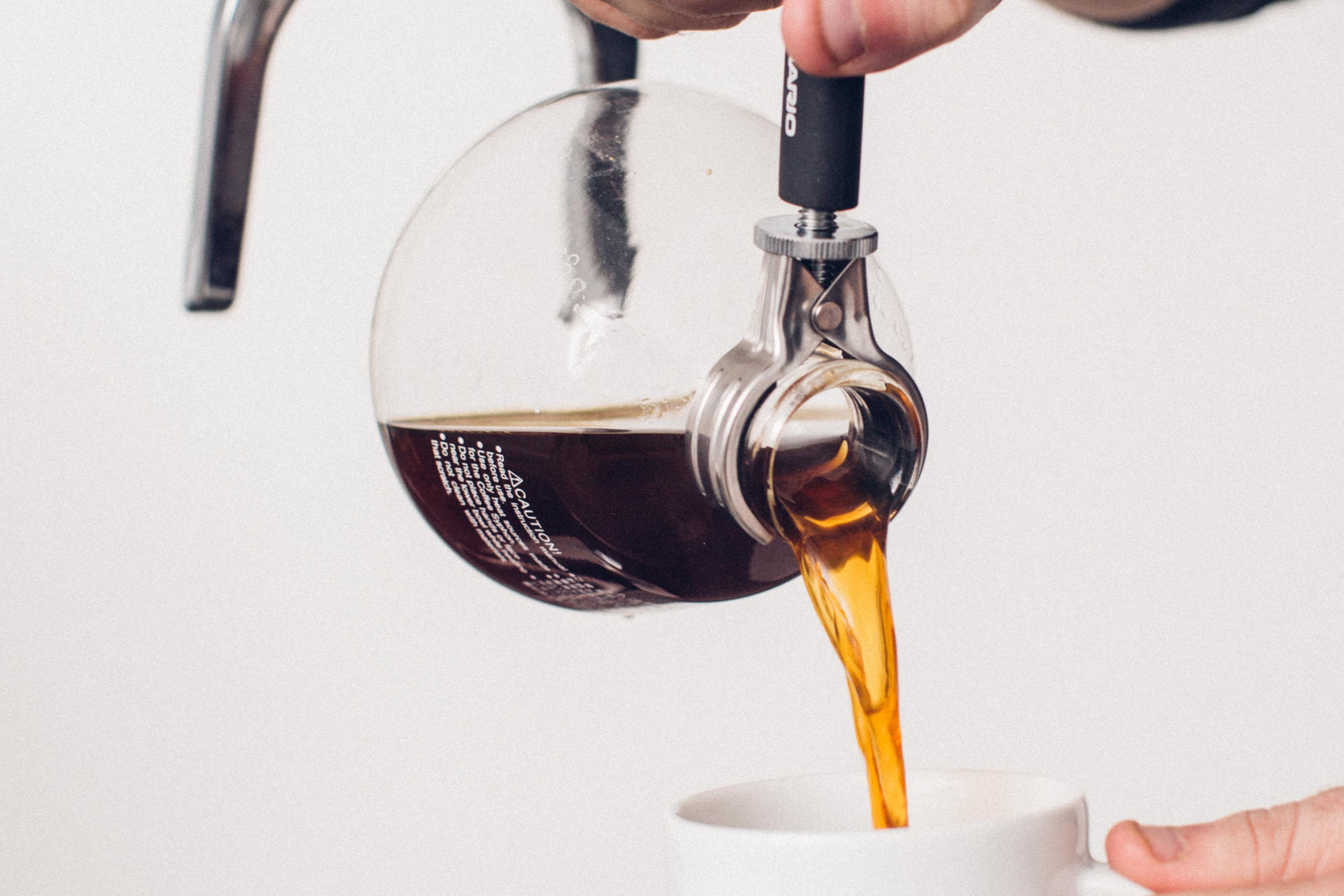 Pouring coffee from a Siphon