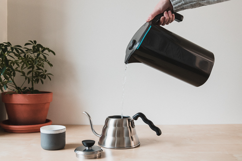 Peak water pitcher pouring water into a kettle