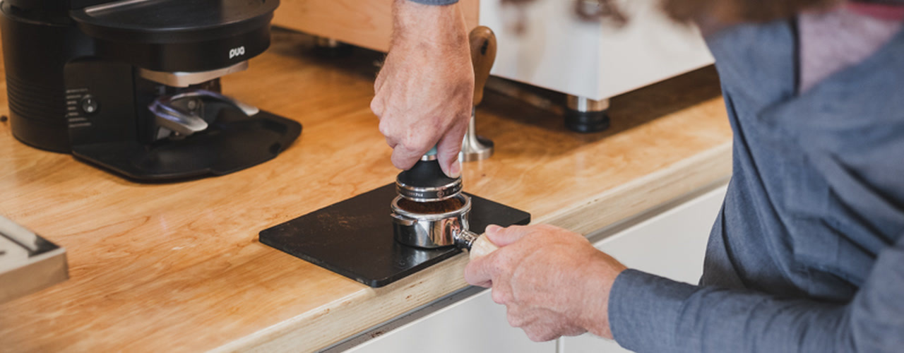 Barista tamping espresso