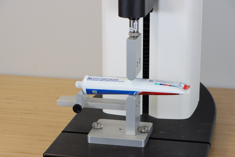 Tube Extrusion Jig measures the force needed to squeeze cream, paste or ointment out of a tube.