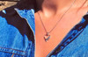 Montana Yogo Sapphire 3 Stone Open Heart Pendant on the neck.