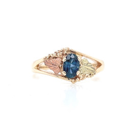 Montana sapphire Black Hills Gold ring leaves on each side.