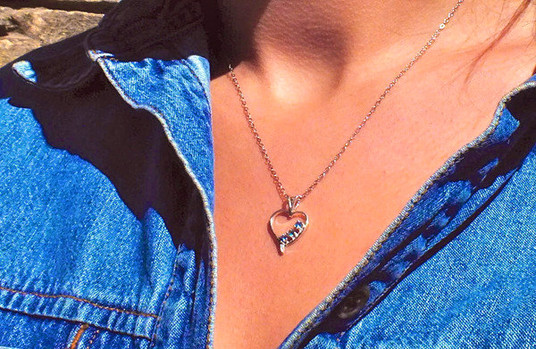 Montana sapphire 3 stone open heart pendant shown on neck Montana sapphire 3 stone open heart pendant shown on neck