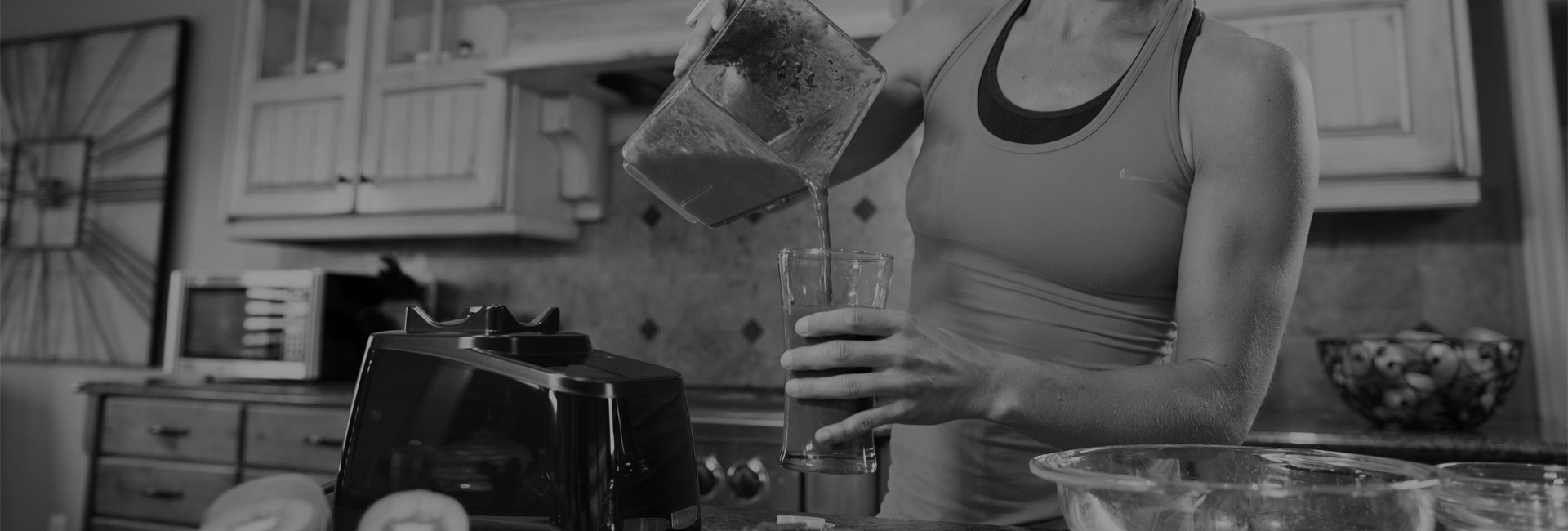 person pouring a smoothie from a blendte blender