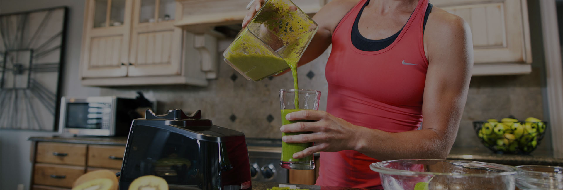 person pouring a smoothie from a blendte blender