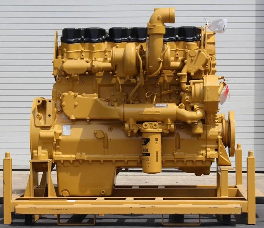 Caterpillar 3406E factory reman engine, front-left angle view showing turbocharger, intake manifold, and valve covers with orange warning tag