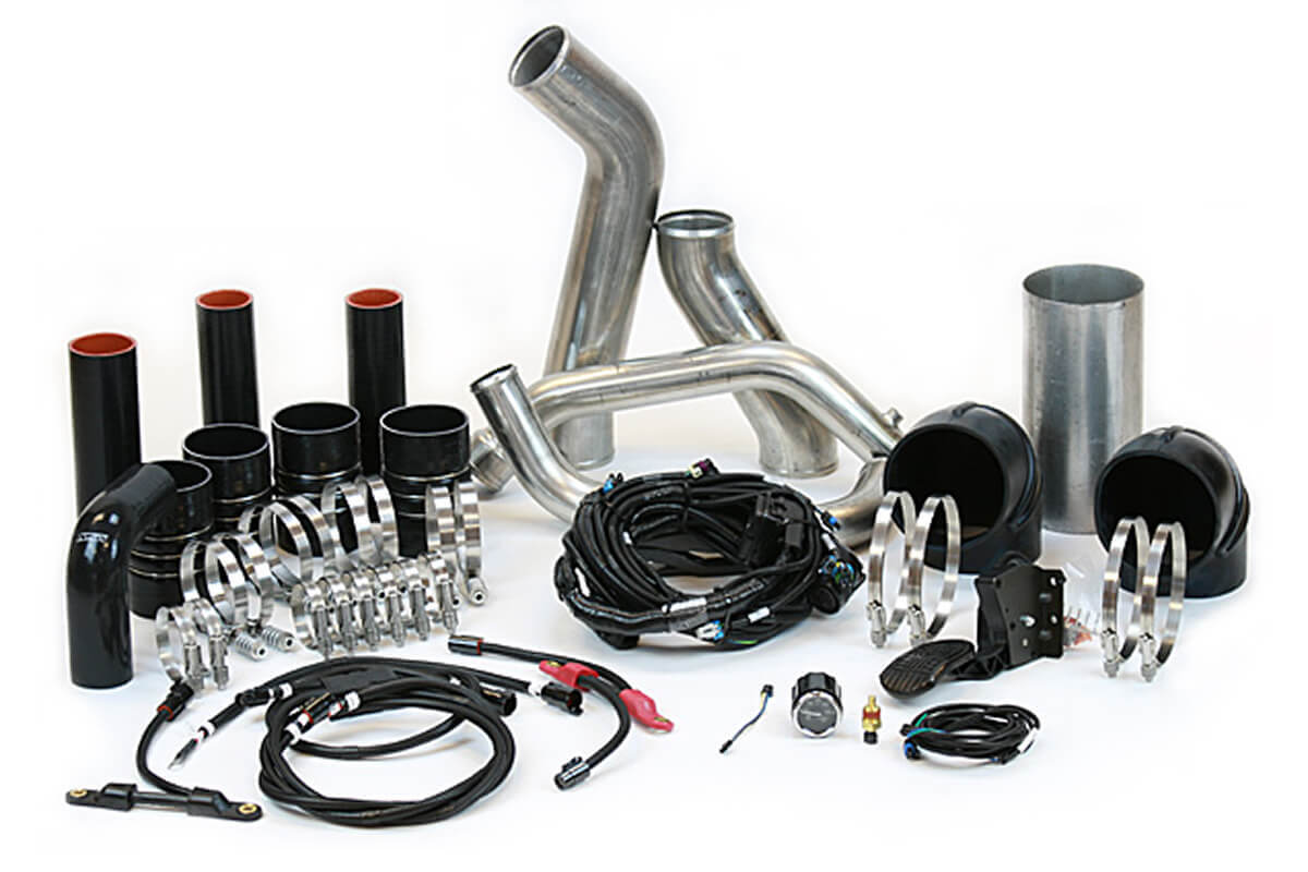 Cummins to CAT engine swap kit components including piping, harnesses, and clamps