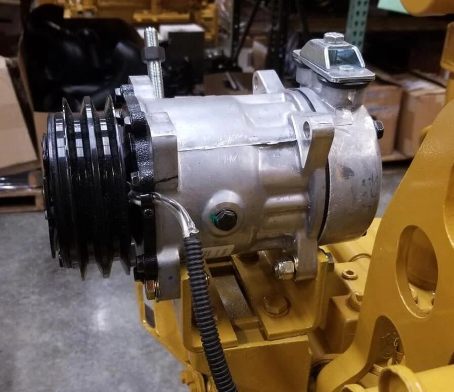 Serpentine belt configuration mounted on a Caterpillar engine with AC Compressor, Alternator and fan hub.