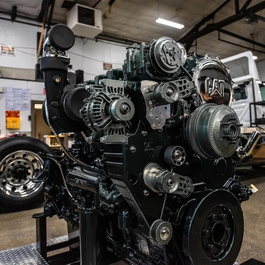 Serpentine belt configuration mounted on a Caterpillar engine with AC Compressor, Alternator and fan hub.