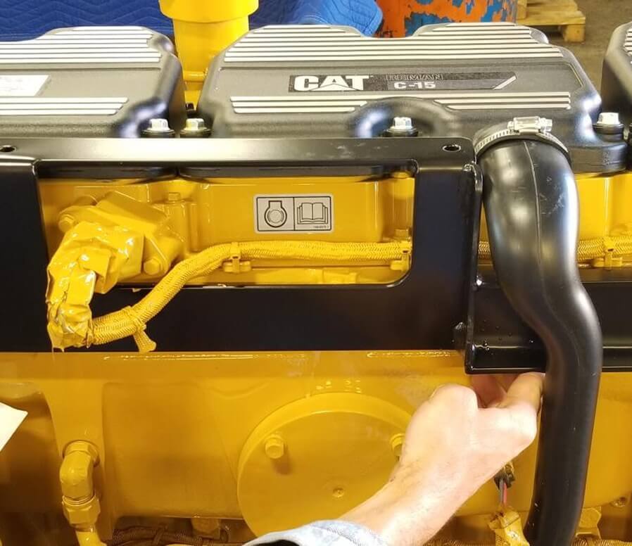 Caterpillar rear engine mounting bracket assembly showing bolt-down attachment points and Grade 8 hardware for chassis conversion